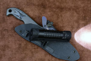 "Contego" Counterterrorism Tactical Knife, sheathed view with HULA articulation detail, in T3 cryogenically treated CPM154CM  powder metal technology high molybdenum martensitic stainless steel blade, 304 stainless steel bolsters, Black/Gray G10 fiberglass/epoxy composite handle, hybrid tension tab-locking sheath in kydex, anodized aluminum, stainless steel, titanium