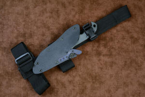 "Contego" Counterterrorism Tactical Knife, sheathed view with EXBLX mounted, front side, in T3 cryogenically treated CPM154CM  powder metal technology high molybdenum martensitic stainless steel blade, 304 stainless steel bolsters, Black/Gray G10 fiberglass/epoxy composite handle, hybrid tension tab-locking sheath in kydex, anodized aluminum, stainless steel, titanium