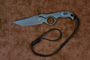 "Contego" Counterterrorism Tactical Knife, noose lanyard shown tightened at wrist, in T3 cryogenically treated CPM154CM  powder metal technology high molybdenum martensitic stainless steel blade, 304 stainless steel bolsters, Black/Gray G10 fiberglass/epoxy composite handle, hybrid tension tab-locking sheath in kydex, anodized aluminum, stainless steel, titanium