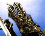 Dragonslayer head detail with gemstone weyes in bronze 