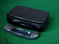 Showing the reflective polish of the Black Galaxy Granite case for this "Gemini" folding knife