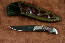"Lacerta" obverse side view (with reflector above), in deep cryogenically treated O1 tungsten-vanadium tool steel blade, hot blued, 304 stainless steel bolsters, Eudialite gemstone handle, sheath of hand-carved leather inlaid with Ostrich leg skin