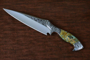 "Malaka" fine custom handmade knife, obverse side view  in hand-engraved CPM 154CM powder metal technology stainless steel, T4 deep cryogenically treated, bolsters of hand-engraved 304 stainless steel, Plasma agate and Nephrite Jade gemstone handle, hand-carved leather crossdraw sheath with stainless steel hardware