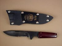 After 15 years of use, USAF Pararescue "Paraeagle" obverse side view in hot blued O1 high carbon tungsten-vanadium tool steel blade, maroon Micarta phenolic handle, nickel silver pins, tension sheath in kydex, aluminum, nickel plated steel