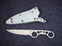 "Shank" obverse side view, tactical knife in ATS-34 high molybdenum stainless steel blade, milled and bead blasted, locking kydex, aluminum, stainless steel, blued steel sheath