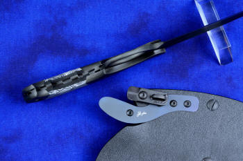 "Skeg"  tactical, counterterrorism, crossover knife, inside handle tang view in T4 Cryogenically treated ATS-34 high molybdenum martensitic stainless steel blade, 304 stainless steel bolsters, white and black tortoiseshell pattern G10 fiberglass/epoxy composite handle with Micarta phenolic spacers, hybrid tension tab-locking sheath in kydex, anodized aluminum, black oxide stainless steel and anodized titanium