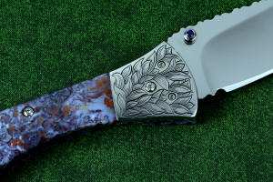 "Starling" fine custom handmade folding knife detail, reverse side, hand-engraved bolsters and fasteners, bezel-set faceted blue amethyst gemstone "Starling" fine custom handmade folding knife detail, reverse side, hand-engraved bolsters and fasteners, bezel-set faceted blue amethyst gemstone
