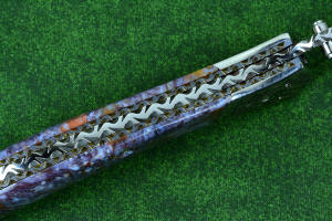 Macro enlargement of "Starling" fine handmade custom folding knife, liner and blade filework detail. Note differentially anodized blue and gold titanium liners and full fine filework throughout Macro enlargement of "Starling" fine handmade custom folding knife, liner and blade filework detail. Note differentially anodized blue and gold titanium liners and full fine filework throughout