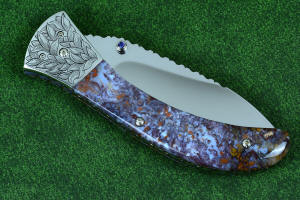 Macro enlargement of "Starling" fine handmade custom folding knife, reverse side view in high molybdenum stainless steel blade, engraved stainless bolsters, faceted amethyst gemstone accents and Rio Grande Agate handle Macro enlargement of "Starling" fine handmade custom folding knife, reverse side view in high molybdenum stainless steel blade, engraved stainless bolsters, faceted amethyst gemstone accents and Rio Grande Agate handle