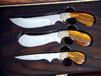 Trophy Game Set knives have hand-engraved brass bolsters and Tiger Eye Quartz gemstone handles