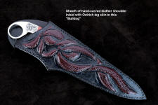 "Bulldog" obverse side view in 440C high chromium stainless steel blade, hand-engraved 304 stainless steel bolsters, Fossilized Stromatolite Algae gemstone handle, hand-carved leather sheath inlaid with burgundy ostrich leg skin