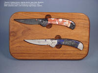 "Gemini Twins" linerlock folding knives in simple display stand with several display options. Handles are lace agate and Peruvian lapis lazuli gemstone